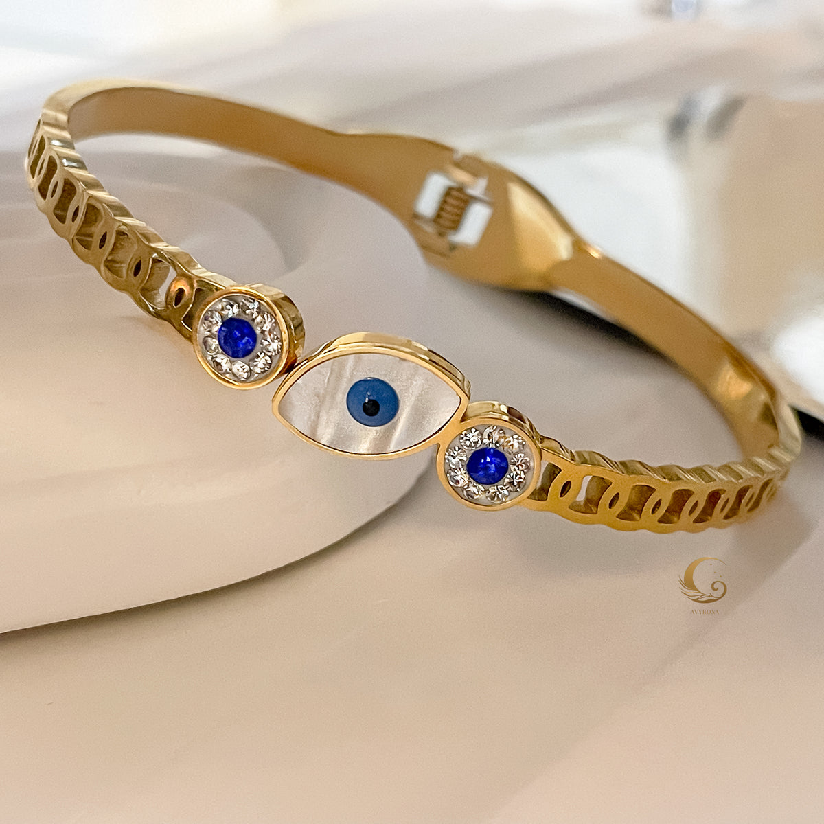 Elina bangle bracelet with Evil Eye symbolism on table
