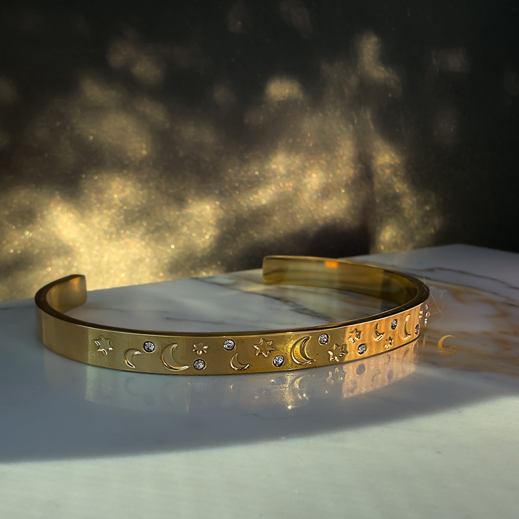 Side view of the Lunara bracelet showcasing detailed celestial engravings and sparkling stones.