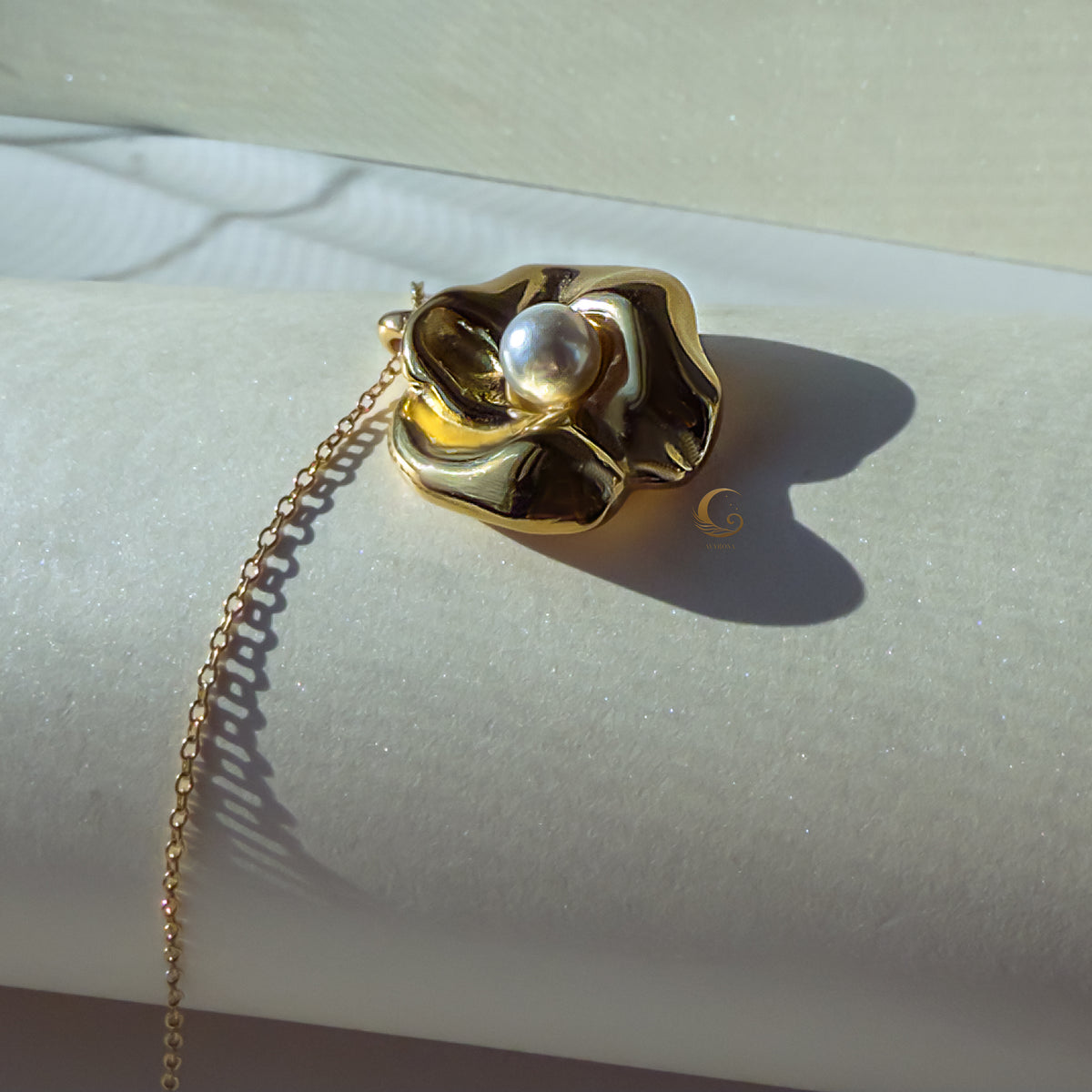 Artistic detail of the Nymira necklace from a side angle, showing pearl setting