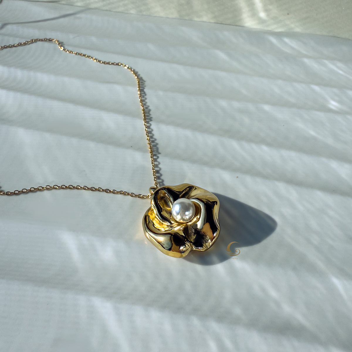 Nymira necklace captured in soft daylight, delicate shadows and natural tones