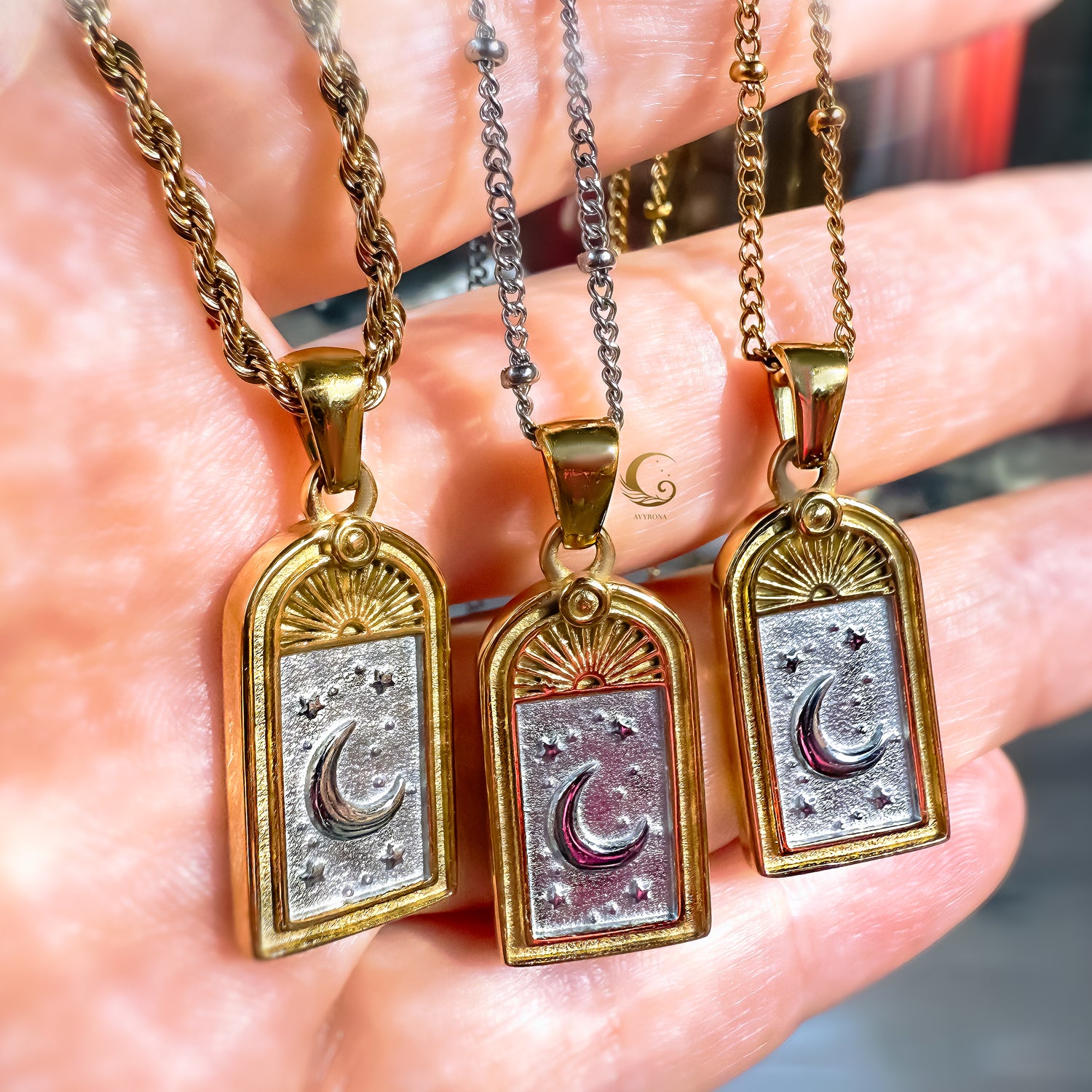 Close-up of three Selara tarot moon necklaces in 18K gold plated and silver stainless steel, showing crescent moon and star engraving with rope and satellite chains — Avyrona jewelry.