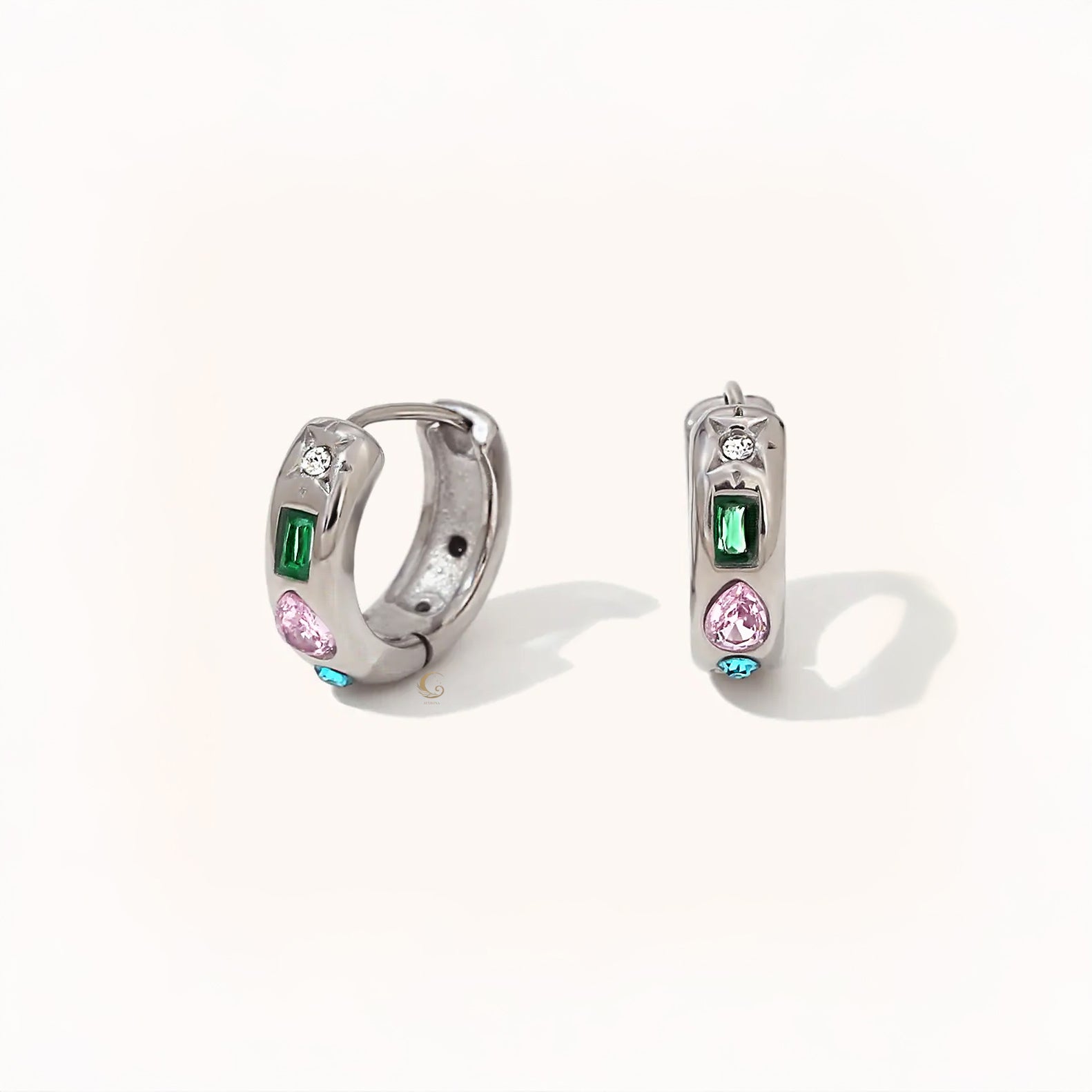Pair of silver hoop earrings featuring multicolored zircon stones – green, pink, white, and blue – in playful shapes.