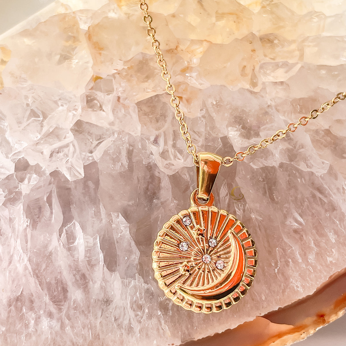 Close-up of Selene Crescent Moon Necklace with sparkling zirconia stones set around the gold pendant, shining like stars in the night sky.