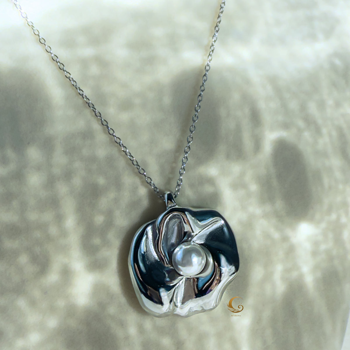 Front-facing view of the silver flower necklace on cream background