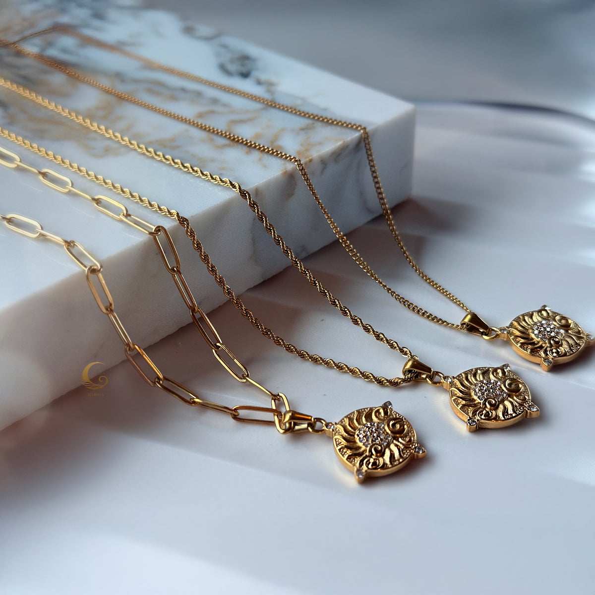 Sun-inspired necklaces with unique chains arranged under soft daylight — a tribute to your inner shine
