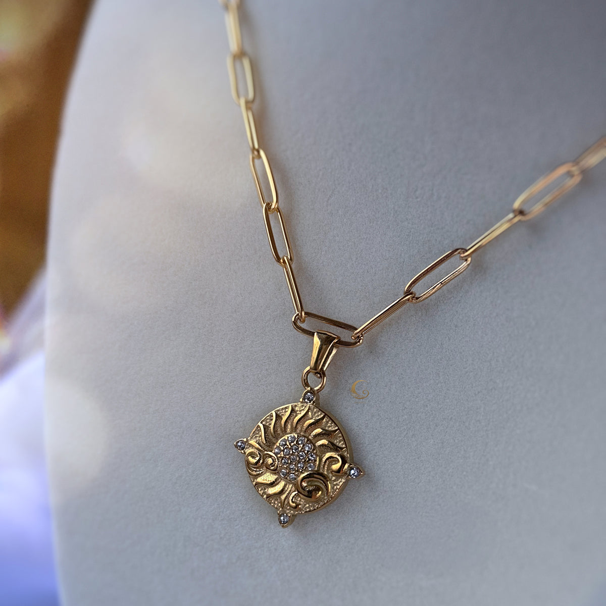 Soleia necklace with paperclip chain displayed solo on white fabric — bold, luminous and airy